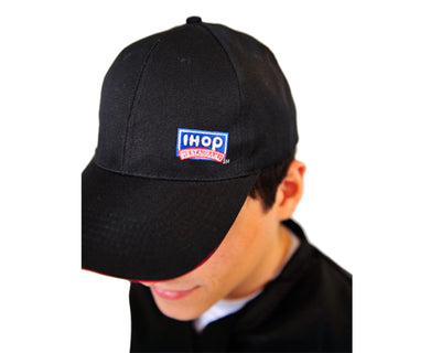 person wearing Baseball IHOP hat in Black