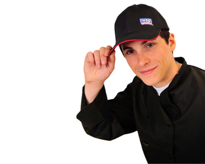 Person holding his Black baseball IHOP hat