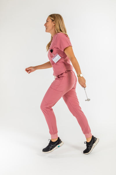 Vena ladies jogger style scrub pants lady in image showing side of the scrub with medical epuipment#style_women#colour_rose