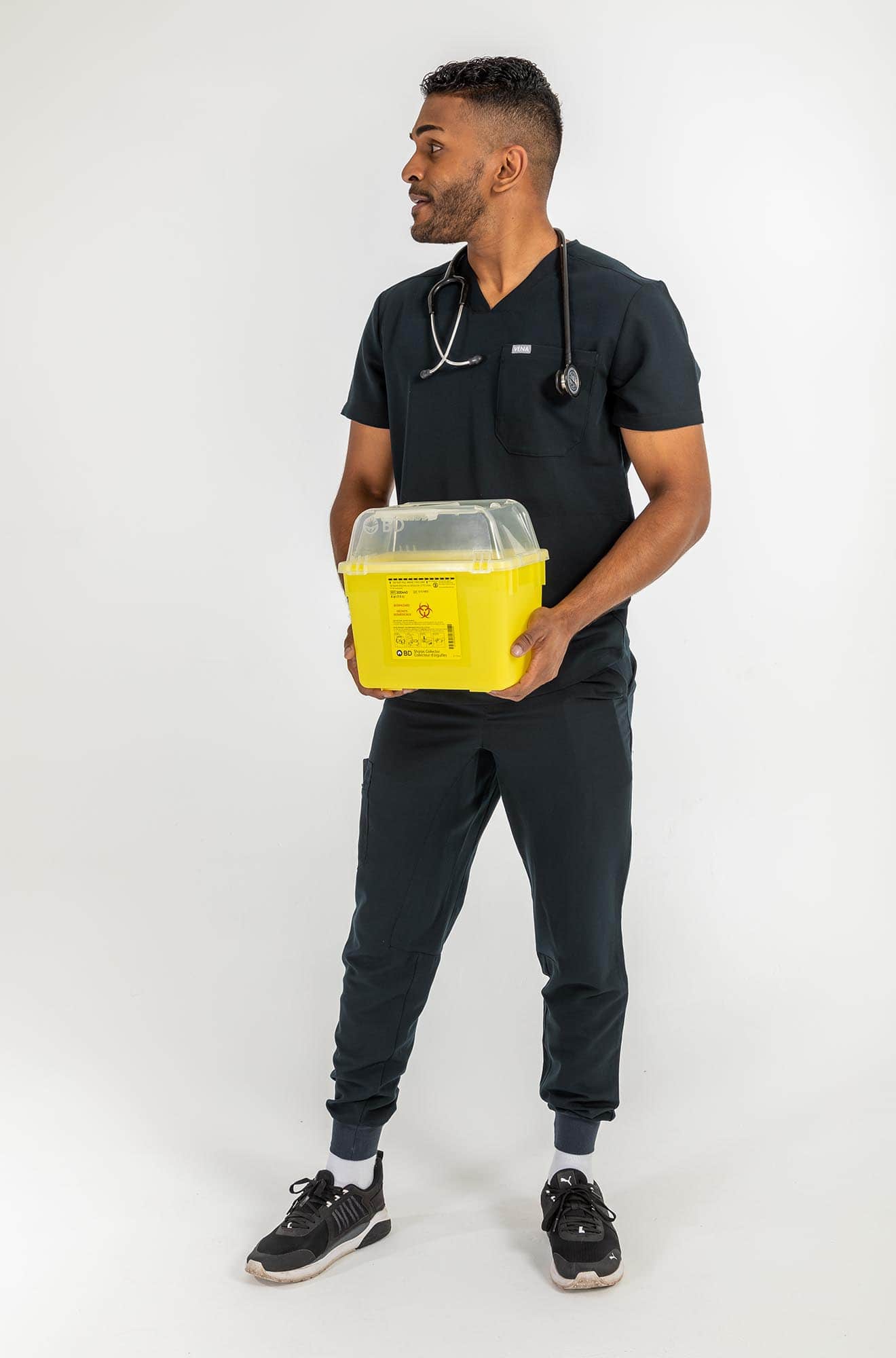 VENA mens jogger style scrub shirts, man holding yellow container#colour_black