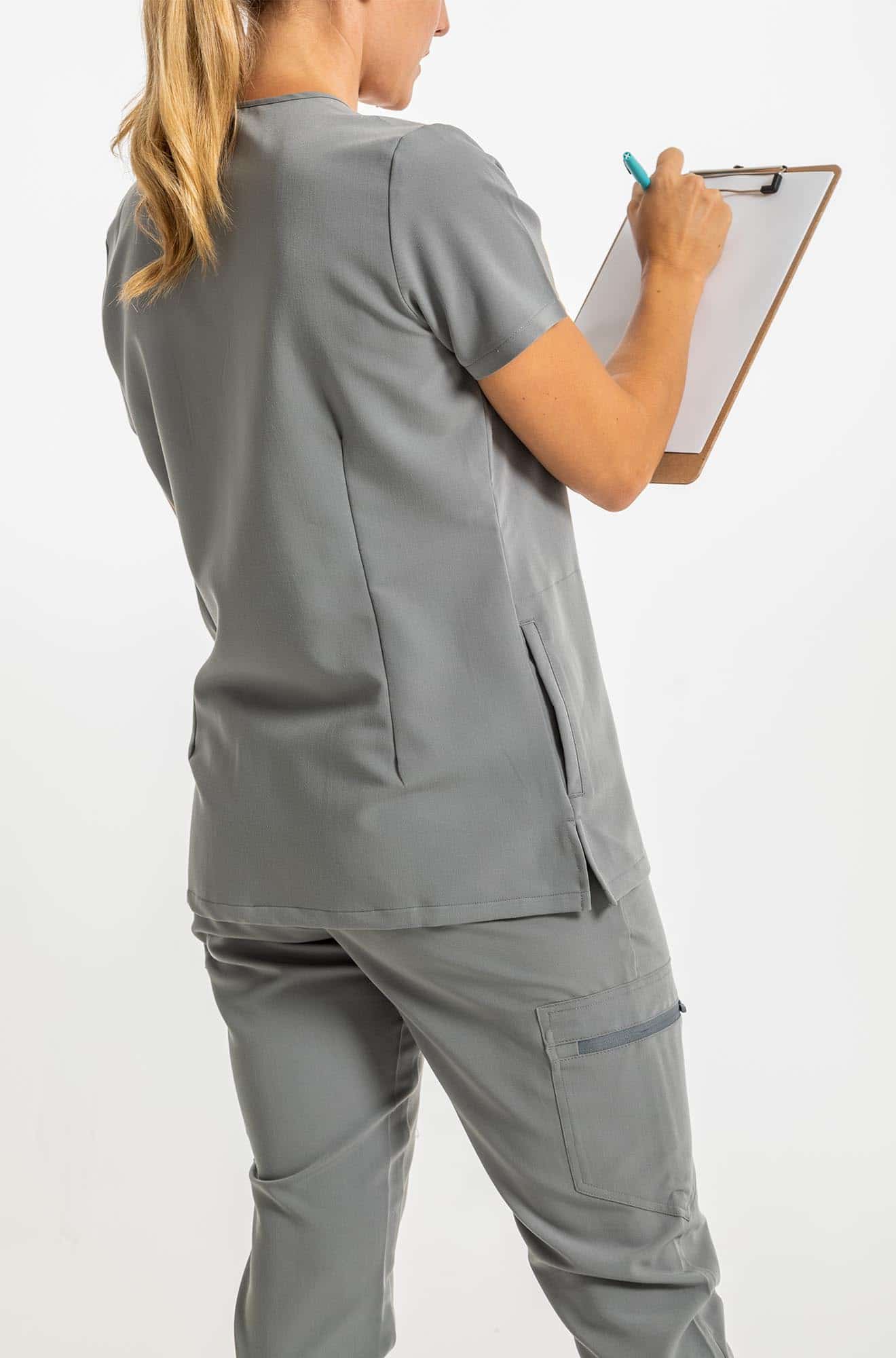 VENA ladies jogger style scrub shirt lady with checklist and pen in her hand#colour_grey