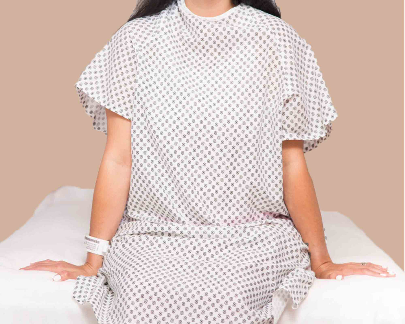 A woman wearing a snowflake hospital patient gown
