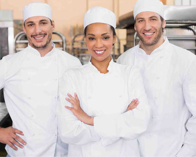 3 chefs wearing white chef coat and white chef hats