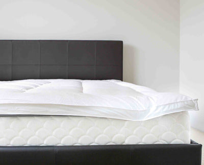 Luxury fiber bed on bed with bed bag encasement covering the mattress