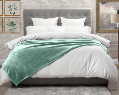 Sage Green Cashmere fleece blanket on the bed #colour_sage-green