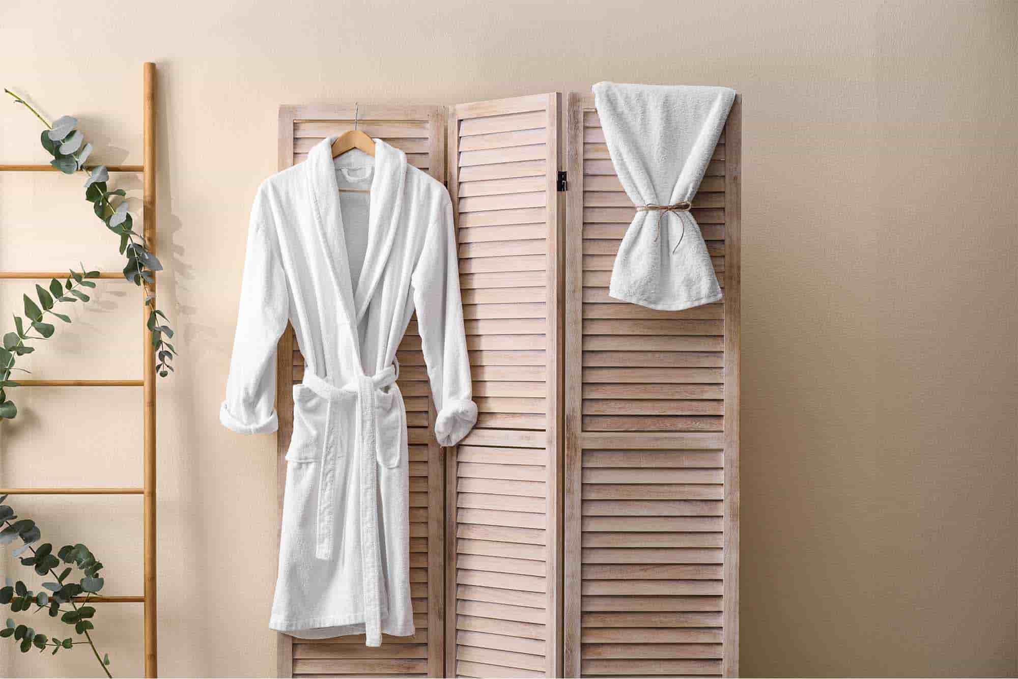 Luxury hotel bathrobe hanging with bath towel in hotel