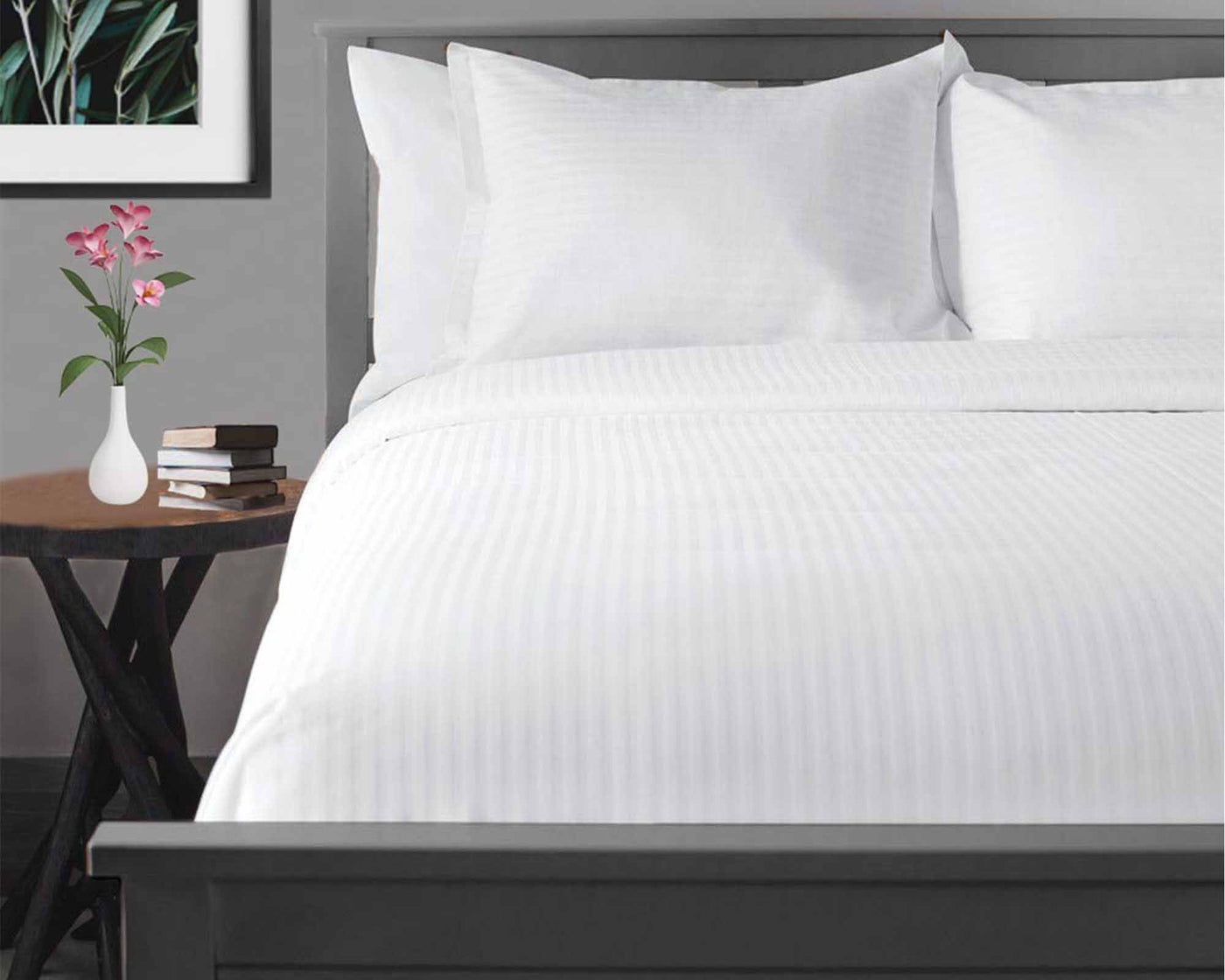 1/4 inch white tone on tone stripe flat sheet on the bed with luxury pillows 