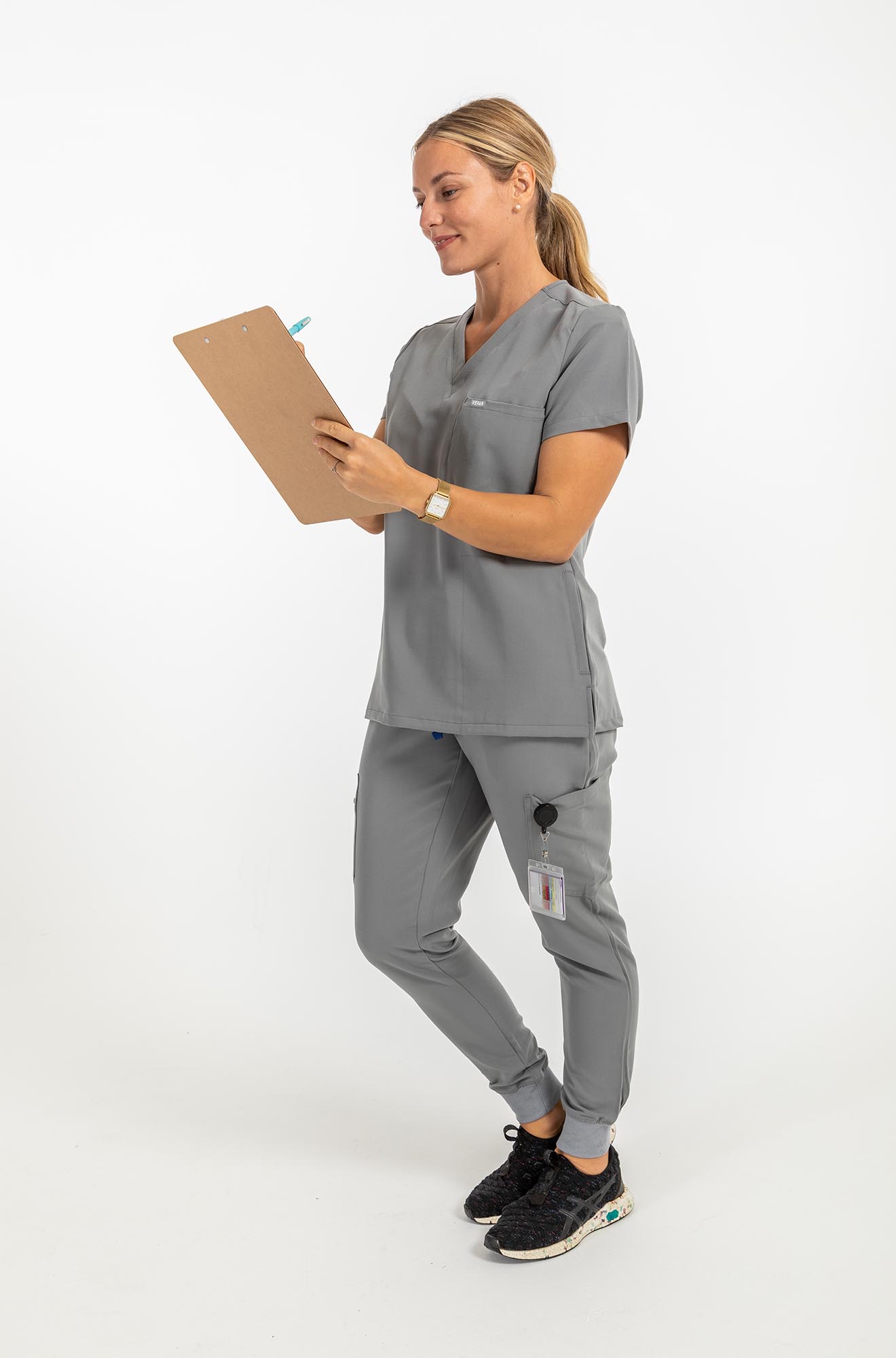 Vena ladies jogger style scrub pants lady with checklist on her hand#colour_grey