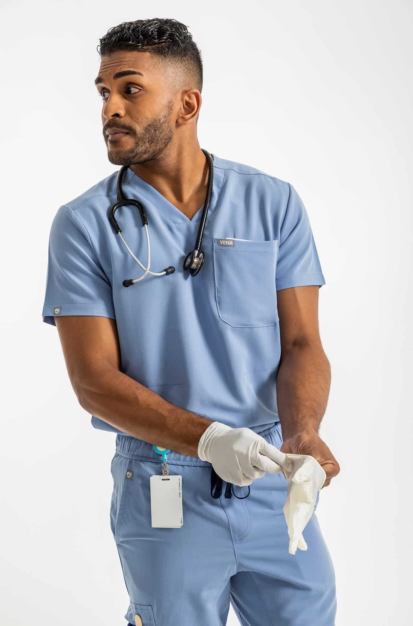 VENA mens jogger style scrub shirt, man wearing gloves in his hands#colour_ceil-blue