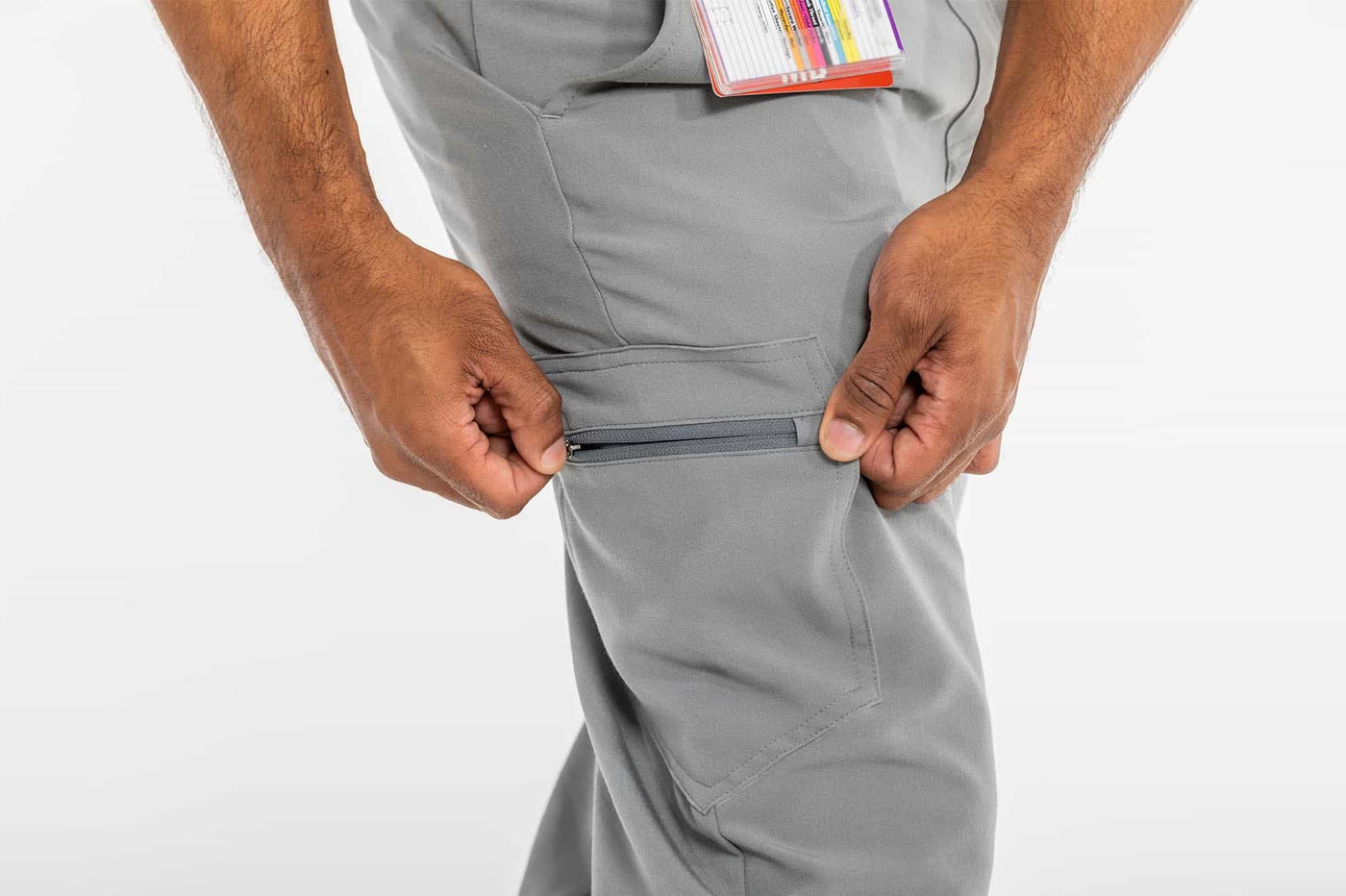 Vena mens jogger scrub pant man holding the side pocket of the scrub#colour_grey