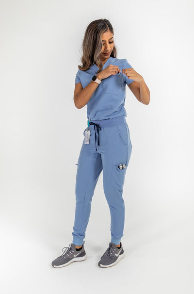 VENA ladies jogger style scrub shirt image showing the chest pocket#colour_ceil-blue