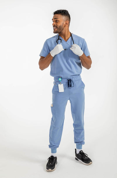 VENA mens jogger style scrub shirt, man holding stethoscope on his neck#colour_ceil-blue