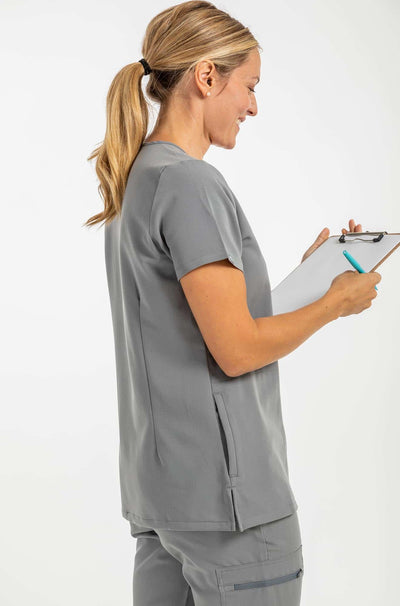 VENA ladies jogger style scrub shirt lady with checklist on her hand#colour_grey