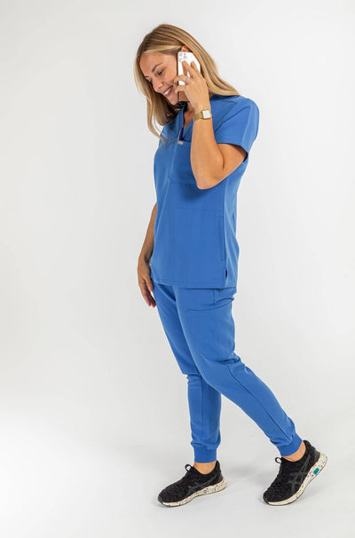 VENA ladies jogger style Scrub shirt lady on her mobile#colour_royal-blue