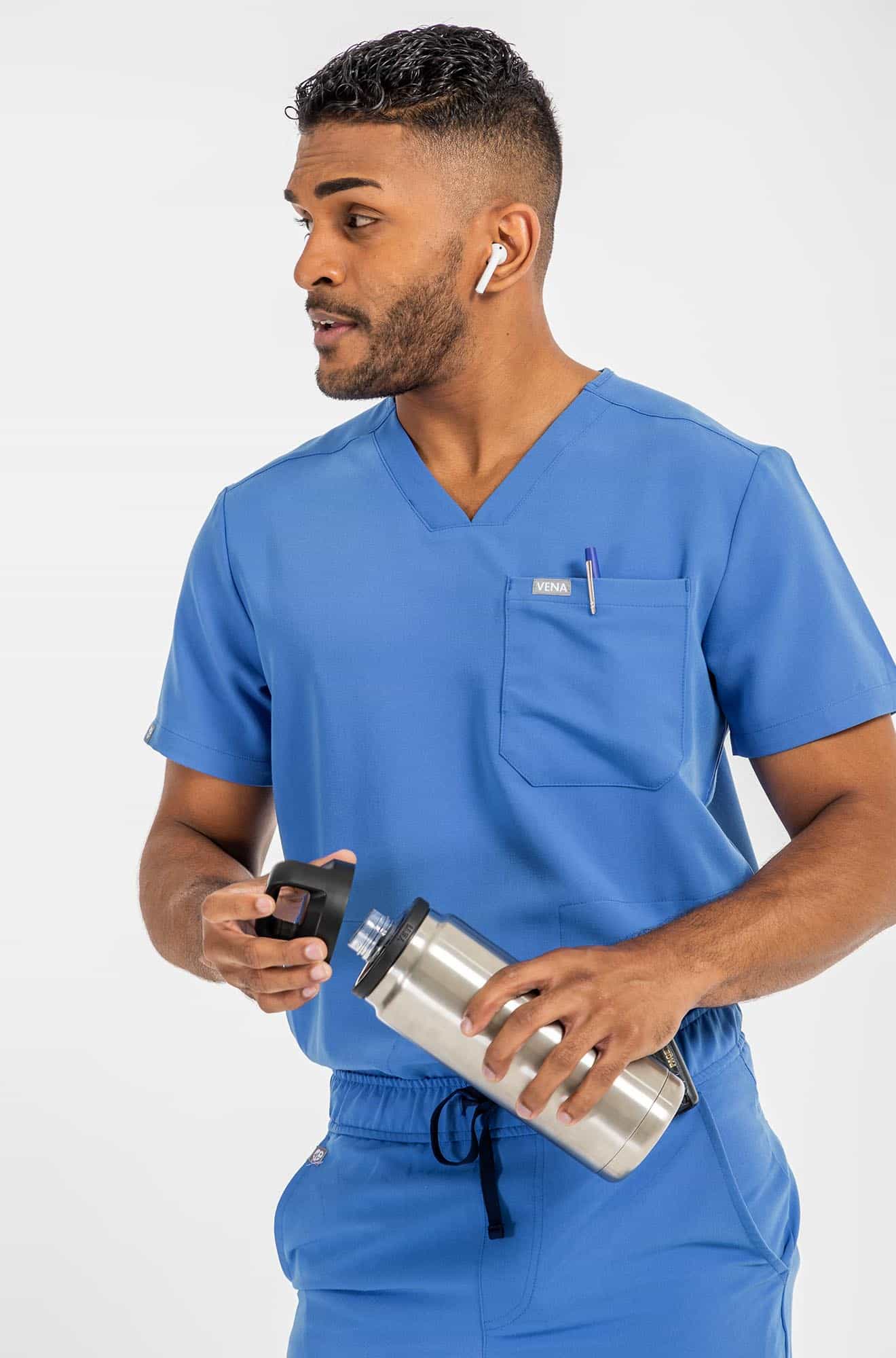 VENA mens jogger style scrub shirts, man holding water bottle#colour_royal-blue